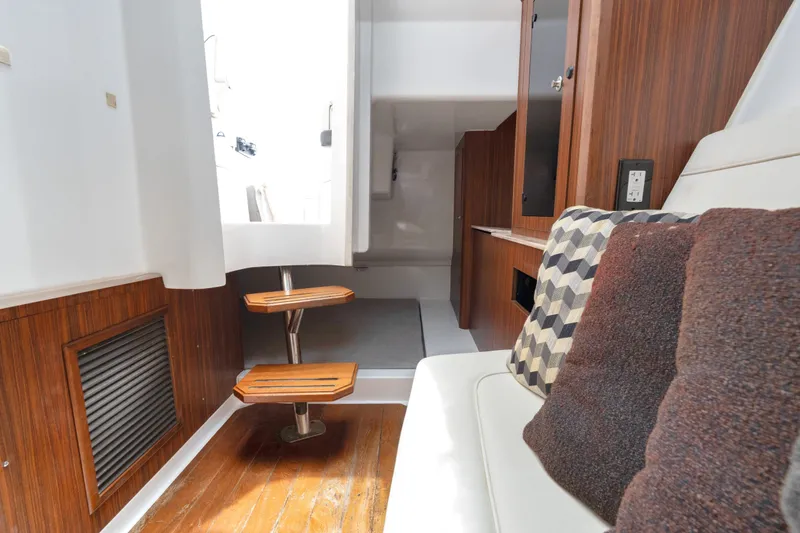 Slide: The Image of Interior of 2018 Pursuit DC 365 Dual Console boat with wooden accents and cozy seating. - 58