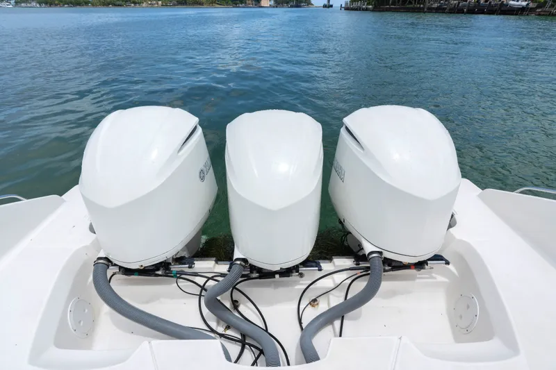Slide: The Image of Triple outboard engines on a 2018 Pursuit DC 365 Dual Console boat. - 21