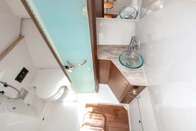Slide: The Image of Luxurious bathroom interior of 2018 Pursuit DC 365 Dual Console boat. - 60
