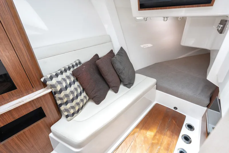 Slide: The Image of Interior of 2018 Pursuit DC 365 Dual Console with cozy seating and cushions. - 56