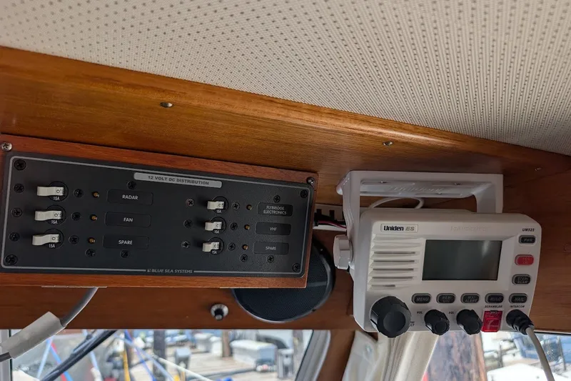 Slide: The Image of 1987 Island Gypsy 32 boat control panel with Uniden marine radio and 12V DC distribution. - 18