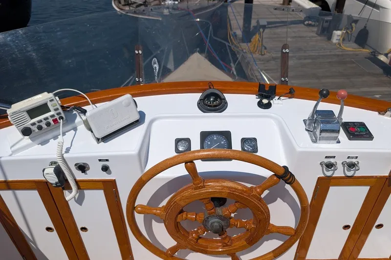 Slide: The Image of Helm of 1987 Island Gypsy 32 boat with wooden wheel and navigation instruments. - 26