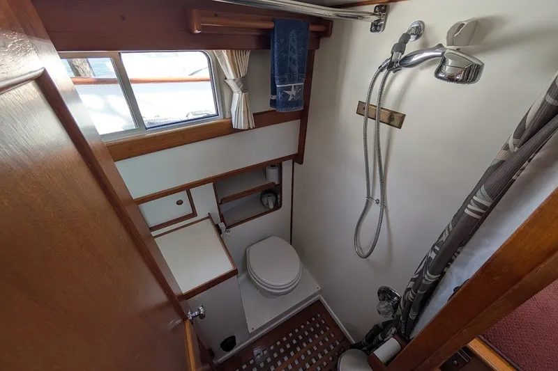 Slide: The Image of Compact bathroom in 1987 Island Gypsy 32 boat with shower and toilet. - 16