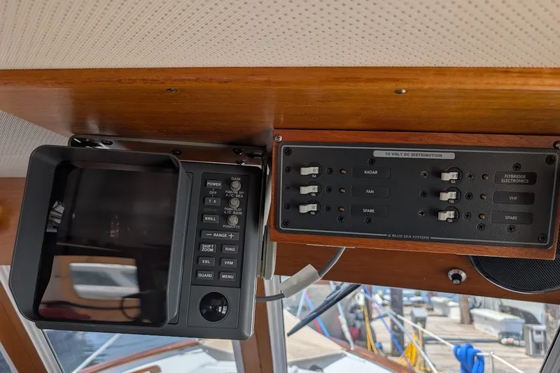 Slide: The Image of Control panel of a 1987 Island Gypsy 32 boat with radar and electronics switches. - 19