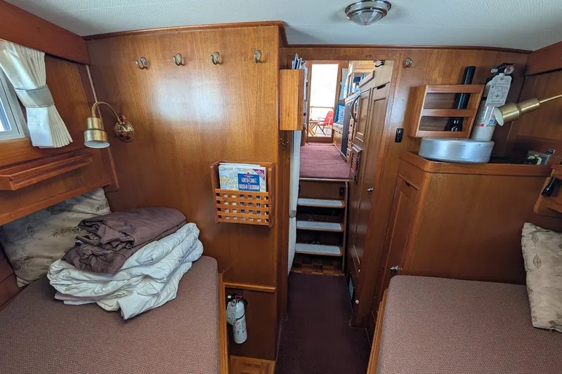 Slide: The Image of Cozy interior of 1987 Island Gypsy 32 boat with wooden furnishings and twin beds. - 14