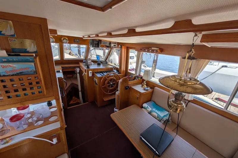 Slide: The Image of Interior of a 1987 Island Gypsy 32 boat, featuring a cozy cabin with wooden accents. - 7