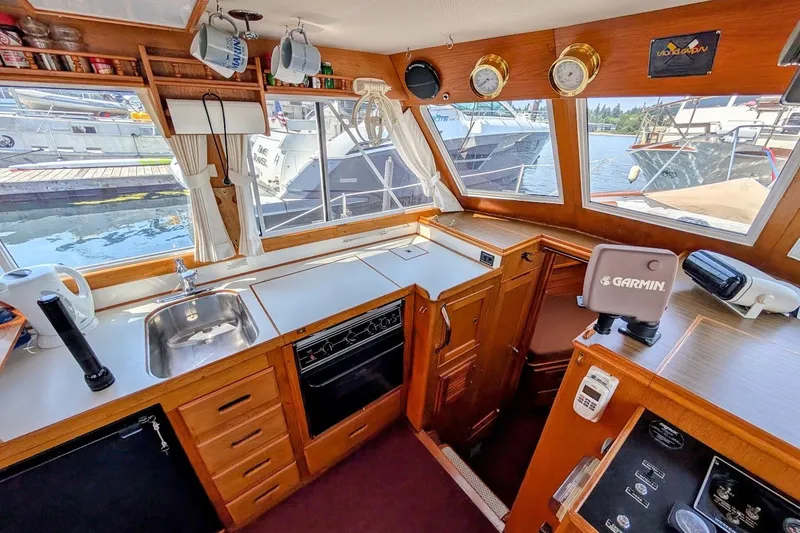 Slide: The Image of Interior of 1987 Island Gypsy 32 boat with kitchen and navigation equipment. - 9