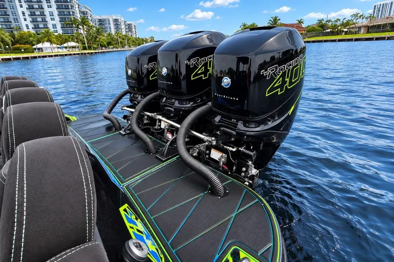 Slide: The Image of 2017 Statement 380 Open boat with triple outboard engines on a calm waterway. - 15