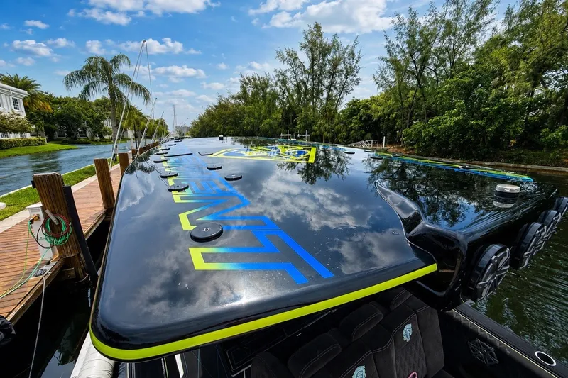 Slide: The Image of 2017 Statement 380 Open boat docked by a scenic canal with lush greenery. - 39