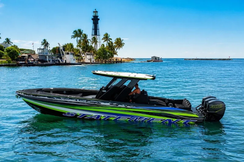 The Image of 2017 Statement 380 Open boat cruising near a lighthouse with palm trees in the background. - 0