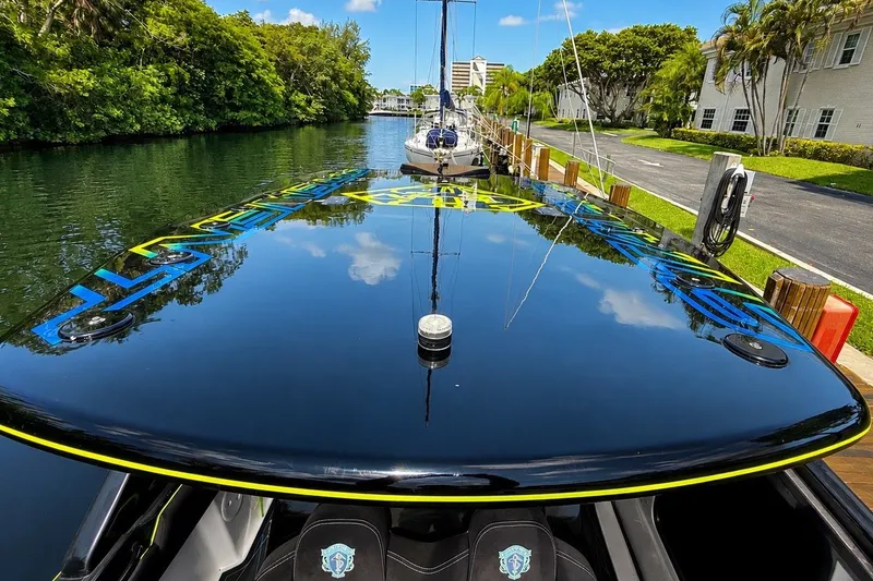 Slide: The Image of 2017 Statement 380 Open boat docked on a serene canal, reflecting blue sky and trees. - 40