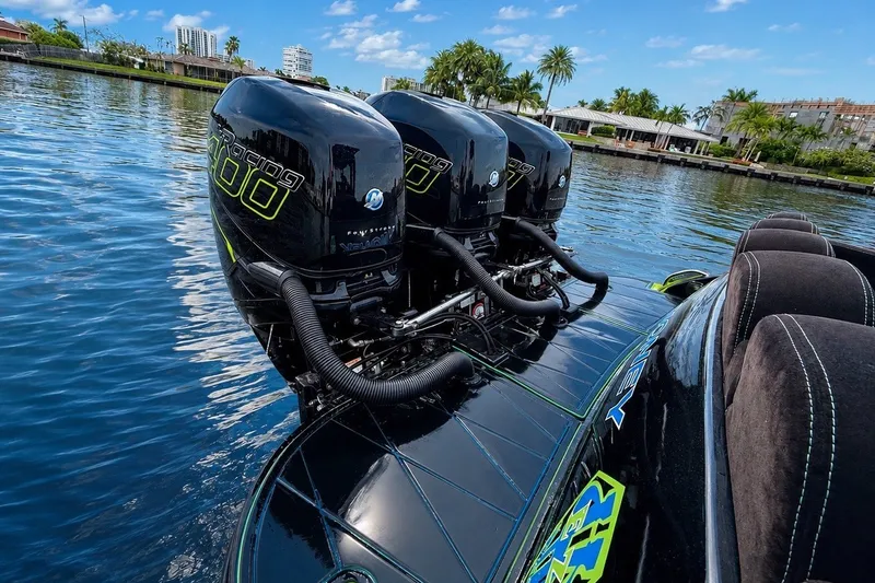 Slide: The Image of 2017 Statement 380 Open boat with triple Mercury Racing 400 engines on a sunny waterway. - 17