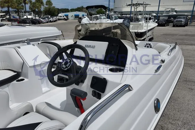 Slide: The Image of The image shows the cockpit of a 2027 Stingray 20 SC boat with a modern helm. - 9