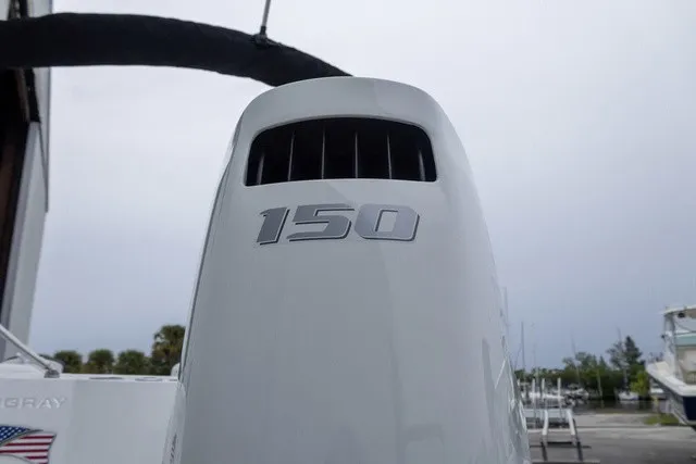 Slide: The Image of Close-up of an outboard motor labeled "150." Boats and trees are visible in the background. - 16