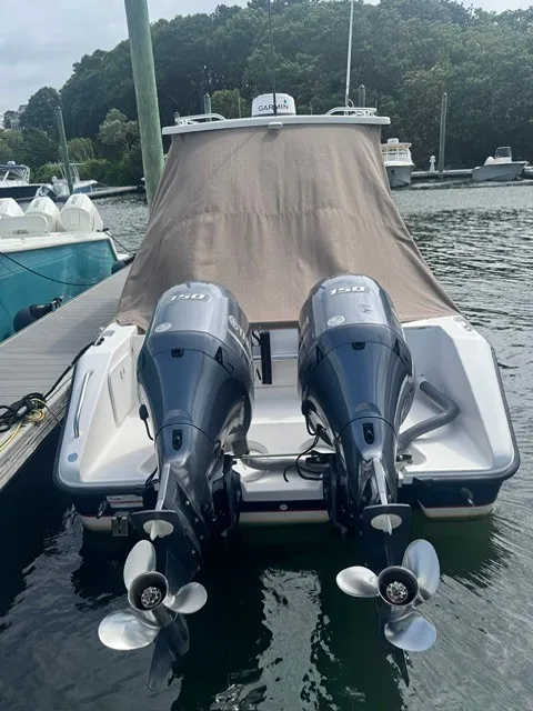 Slide: The Image of A 2016 Pursuit OS 255 Offshore docked. Two outboard engines are visible. - 4