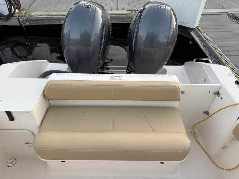 Slide: The Image of A 2016 Pursuit OS 255 Offshore with twin outboard engines and a beige bench seat. - 9