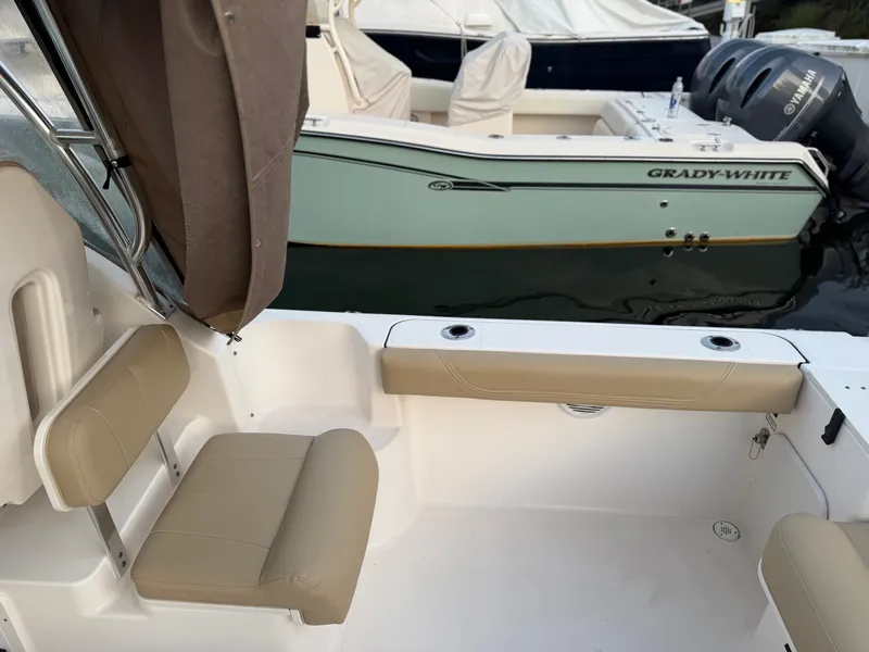 Slide: The Image of The image shows the cockpit of a 2016 Pursuit OS 255 Offshore with beige seating. - 13