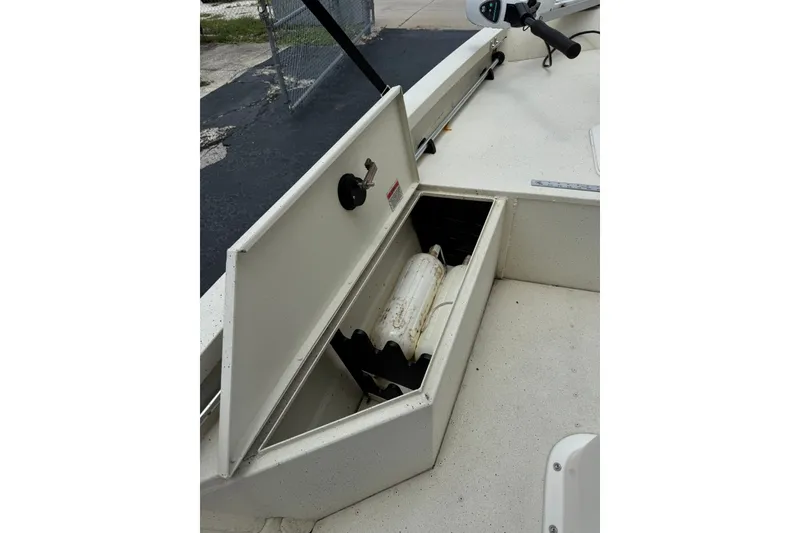 Slide: The Image of 2018 G3 Bay 18 DLX boat storage compartment with open lid and visible equipment. - 12