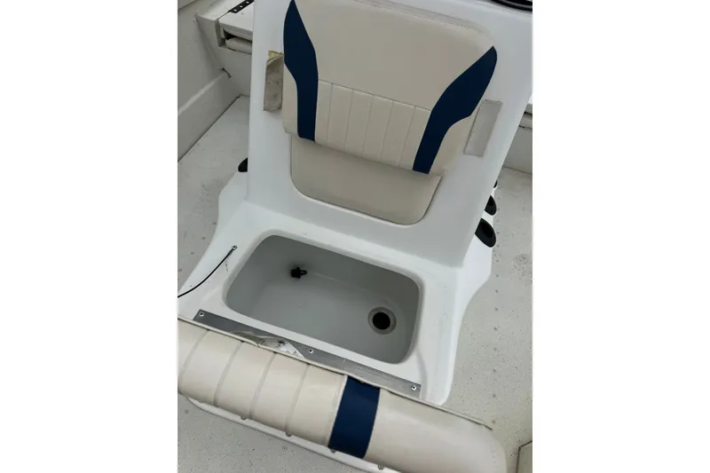 Slide: The Image of 2018 G3 Bay 18 DLX boat seat with storage compartment, featuring blue and beige upholstery. - 15