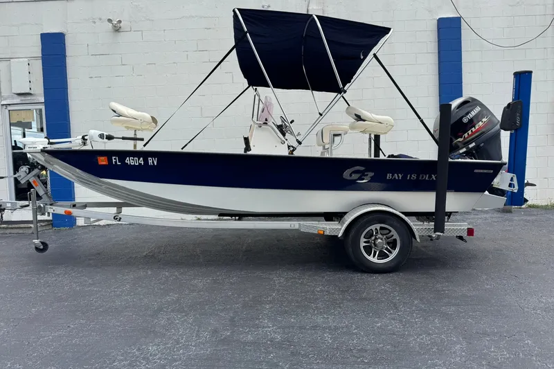 The Image of 2018 G3 Bay 18 DLX boat on trailer with Yamaha outboard motor. - 0