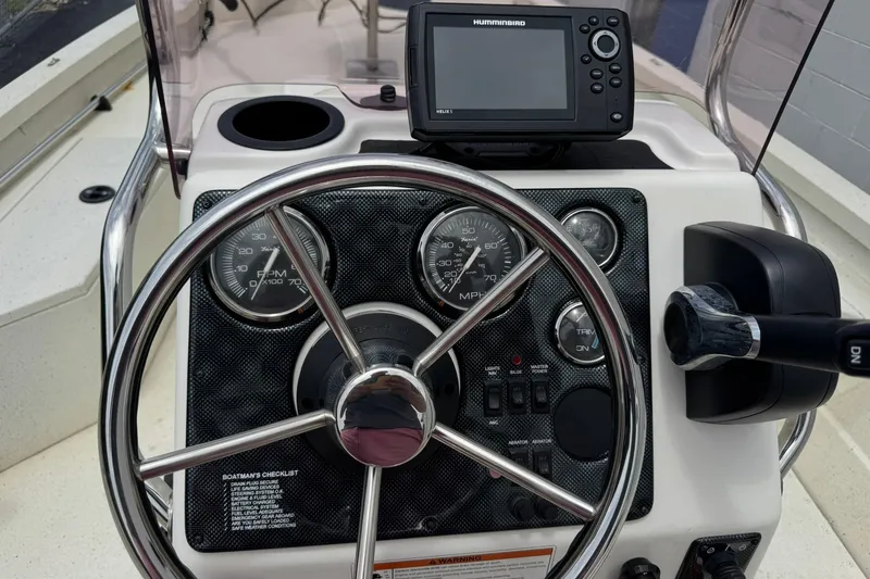 Slide: The Image of 2018 G3 Bay 18 DLX boat dashboard with steering wheel and Humminbird GPS. - 17