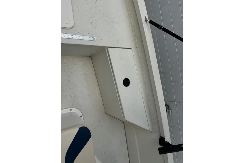 Slide: The Image of 2018 G3 Bay 18 DLX boat interior with storage compartment and rod holder. - 14