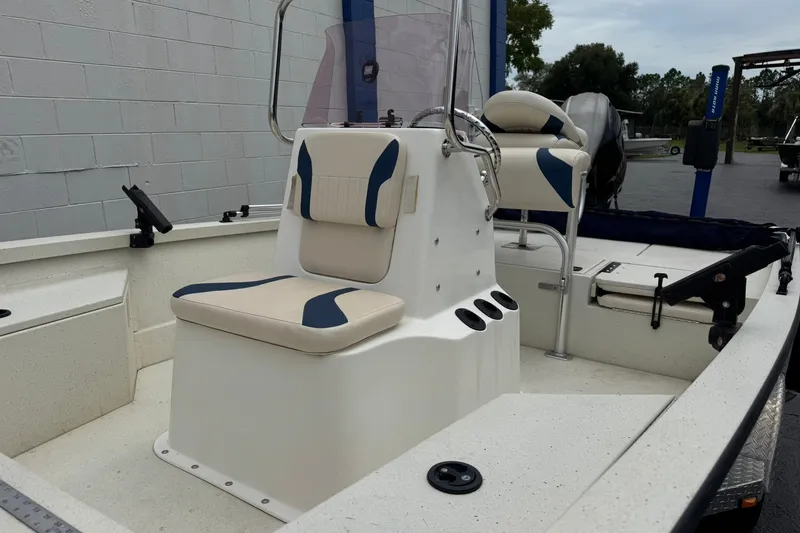 Slide: The Image of 2018 G3 Bay 18 DLX boat interior with cushioned seating and steering console. - 3