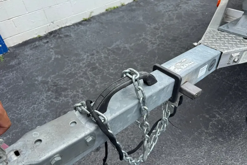 Slide: The Image of Trailer hitch with safety chains on a 2018 G3 Bay 18 DLX boat trailer. - 9