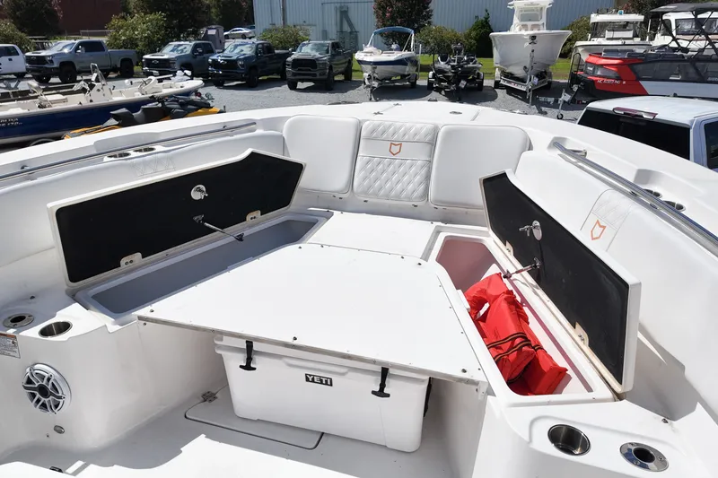 Slide: The Image of 2025 Sea Fox 328 Commander boat interior with storage compartments and Yeti cooler. - 18