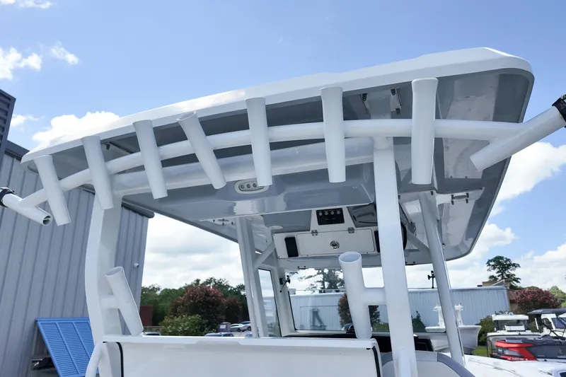 Slide: The Image of 2025 Sea Fox 328 Commander boat with rod holders and T-top under a clear sky. - 10
