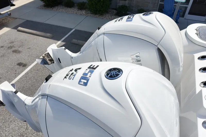 Slide: The Image of Twin Yamaha outboard engines on a 2025 Sea Fox 328 Commander boat, parked on pavement. - 6