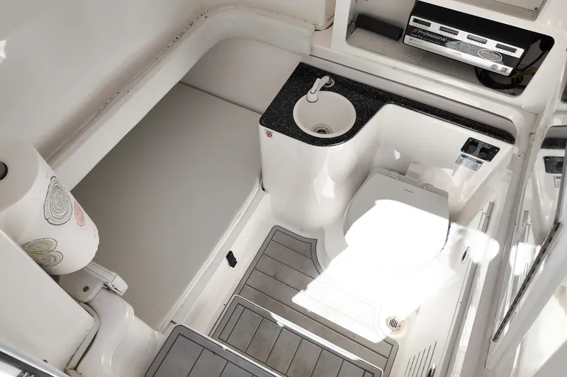 Slide: The Image of 2025 Sea Fox 328 Commander boat bathroom with sink, toilet, and storage space. - 22