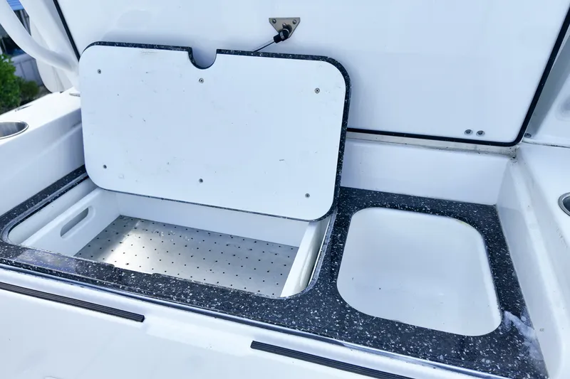 Slide: The Image of Open storage compartment on 2025 Sea Fox 328 Commander boat, featuring a speckled countertop. - 12