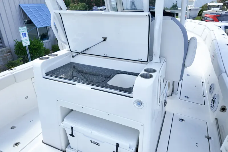Slide: The Image of 2025 Sea Fox 328 Commander boat interior with open storage and cup holders. - 11