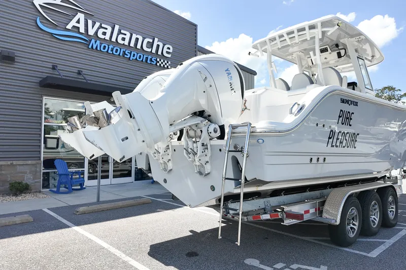 Slide: The Image of 2025 Sea Fox 328 Commander boat on trailer at Avalanche Motorsports dealership. - 2