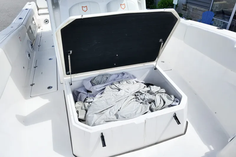 Slide: The Image of Open storage compartment on 2025 Sea Fox 328 Commander boat, containing fabric items. - 17