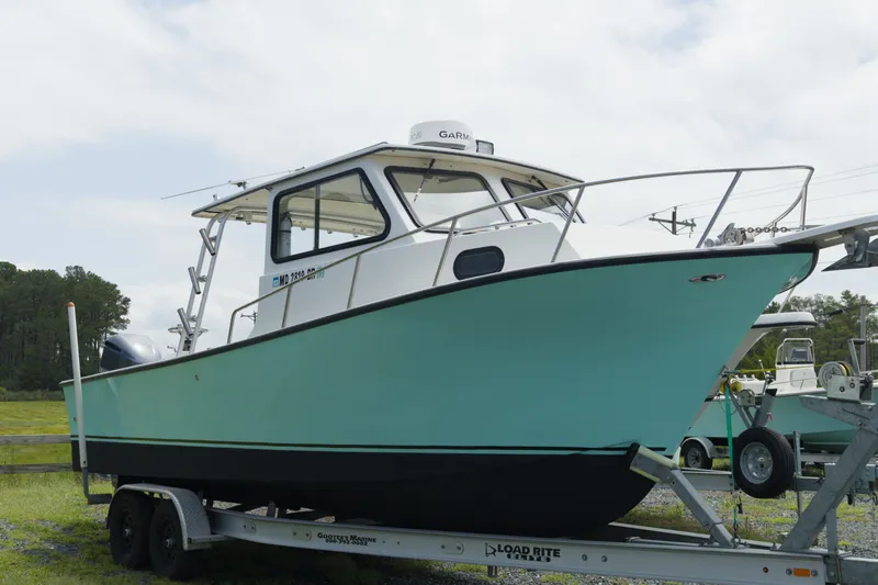 The Image of 2015 May-Craft 25 Cabin XL boat on trailer, side view. - 1