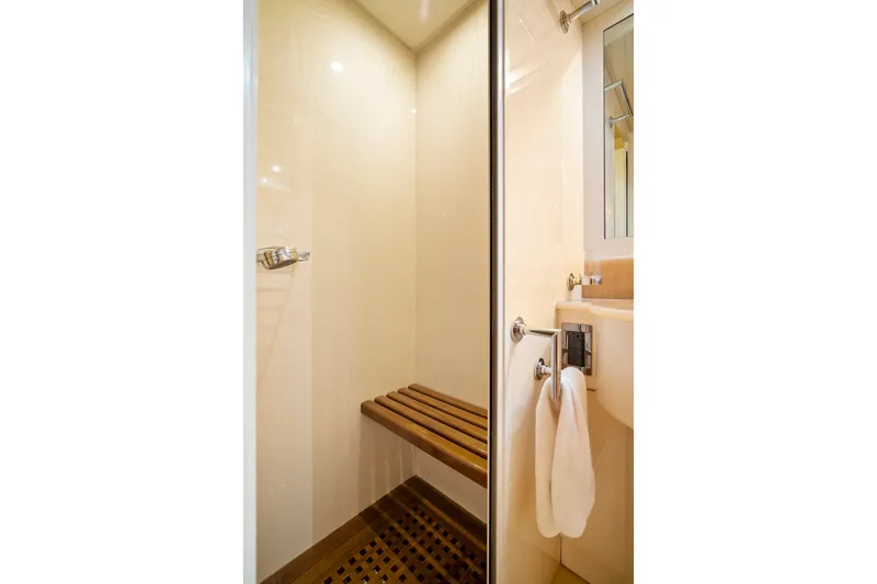 Slide: The Image of Luxurious shower area in 2007 Mangusta 72 Motor Yacht with wooden bench and towel rack. - 45