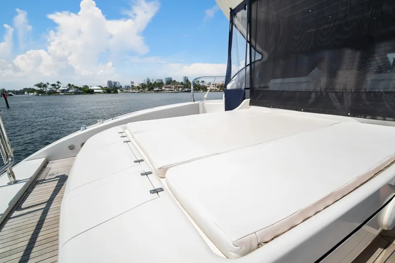 Slide: The Image of 2007 Mangusta 72 Motor Yacht deck with sunbathing area, overlooking scenic waterfront. - 17