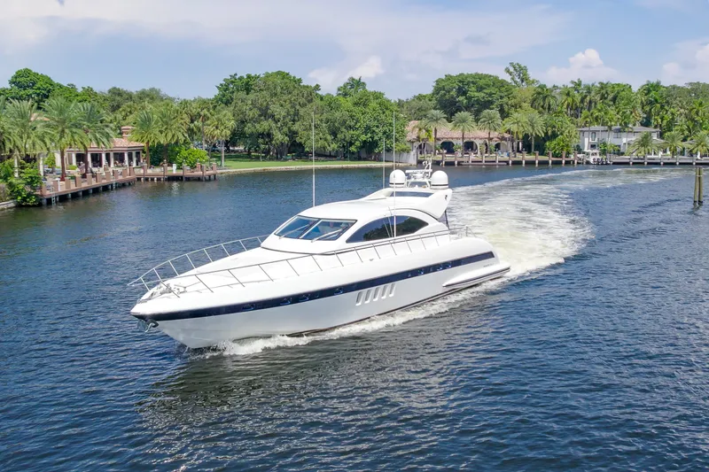 Slide: The Image of 2007 Mangusta 72 Motor Yacht cruising on a scenic waterway with lush greenery. - 10