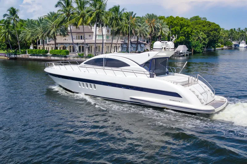 Slide: The Image of Luxurious 2007 Mangusta 72 Motor Yacht cruising on a scenic waterway. - 11
