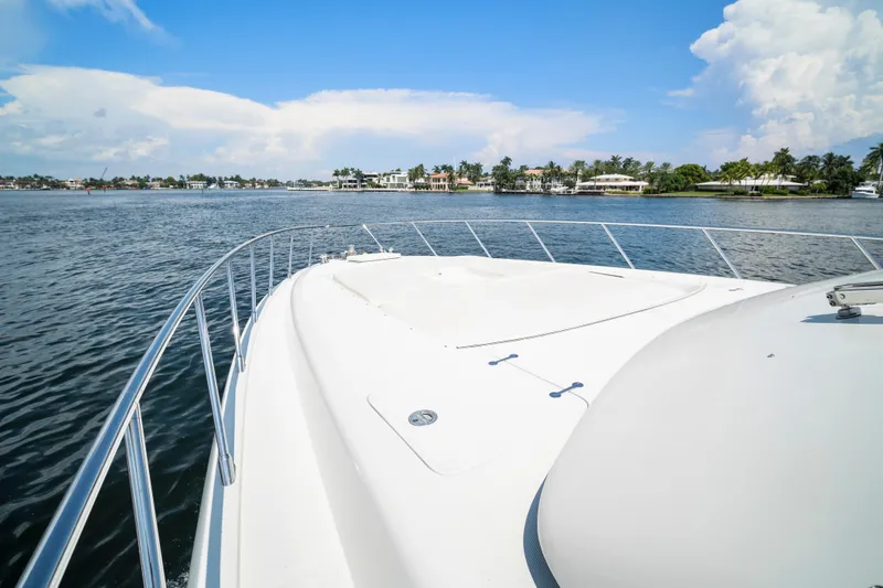 Slide: The Image of 2007 Mangusta 72 Motor Yacht cruising on a sunny day, with scenic waterfront views. - 27