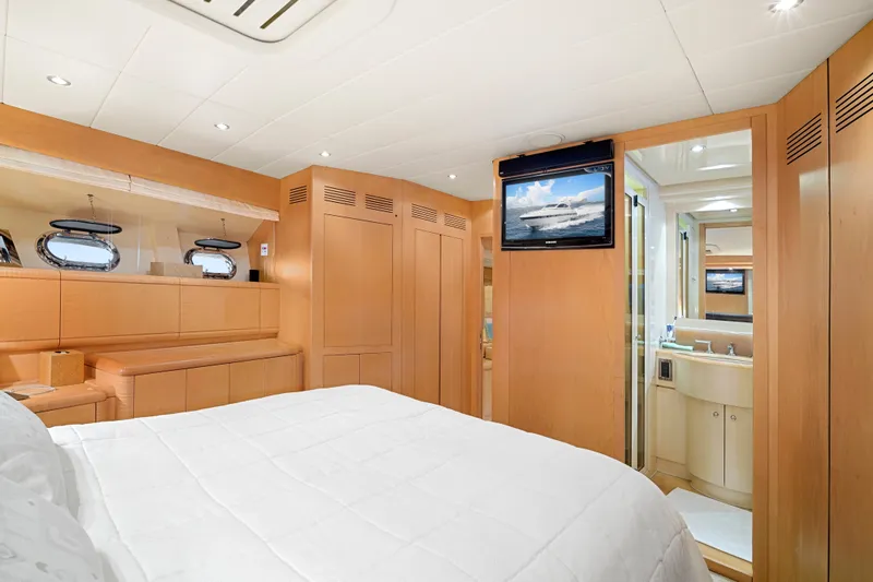 Slide: The Image of Luxurious 2007 Mangusta 72 Motor Yacht bedroom with modern amenities and elegant wood finishes. - 39