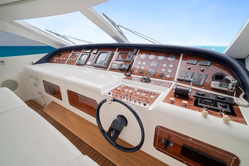 Slide: The Image of Cockpit of 2007 Mangusta 72 Motor Yacht with advanced navigation controls and wooden accents. - 31
