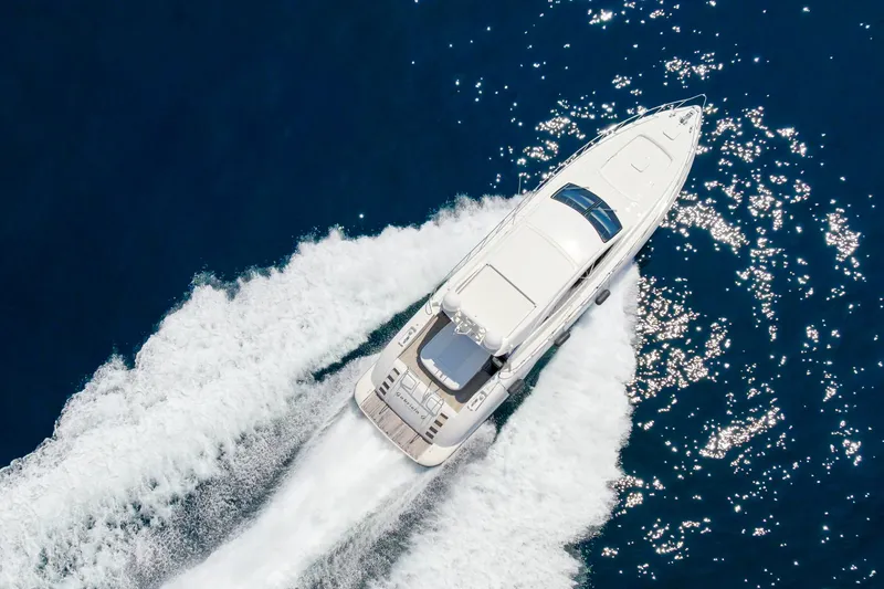 Slide: The Image of Aerial view of 2007 Mangusta 72 Motor Yacht cruising on blue ocean waters. - 13