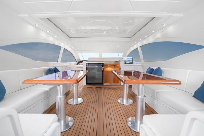 Slide: The Image of Luxurious interior of 2007 Mangusta 72 Motor Yacht with elegant seating and wooden tables. - 20