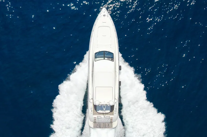 Slide: The Image of Top view of 2007 Mangusta 72 Motor Yacht cruising on blue ocean waters. - 14