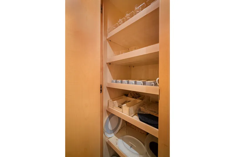 Slide: The Image of Storage shelves with dishes and cups inside a 2007 Mangusta 72 Motor Yacht. - 41