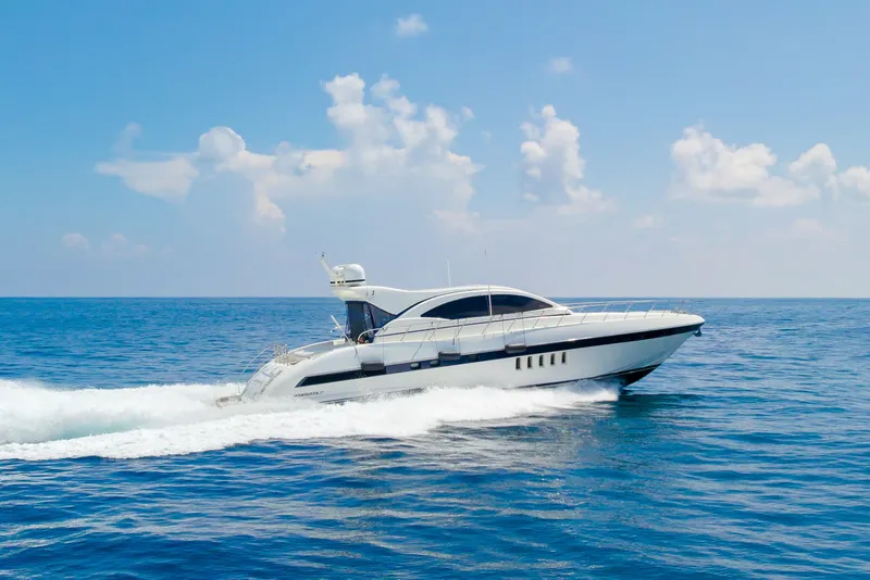 Slide: The Image of 2007 Mangusta 72 Motor Yacht cruising on open sea under clear skies. - 9
