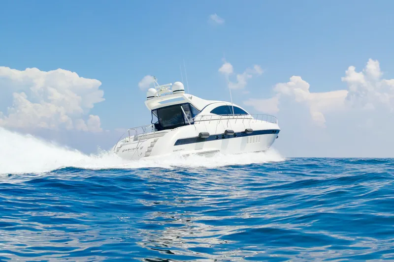 Slide: The Image of Luxurious 2007 Mangusta 72 Motor Yacht cruising on open sea under clear skies. - 7